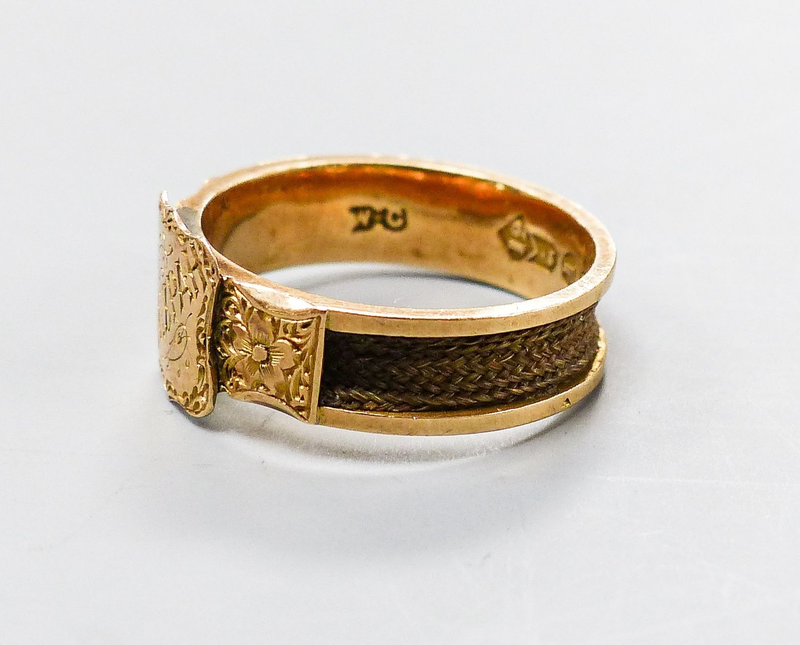 A late Victorian engraved 12ct gold Mizpah mourning ring, with plaited hair within shank, size Q, gross 3.8 grams.